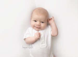 oakville baby photographer - 1 month old newborn Bruce smiling by Hope + Salt